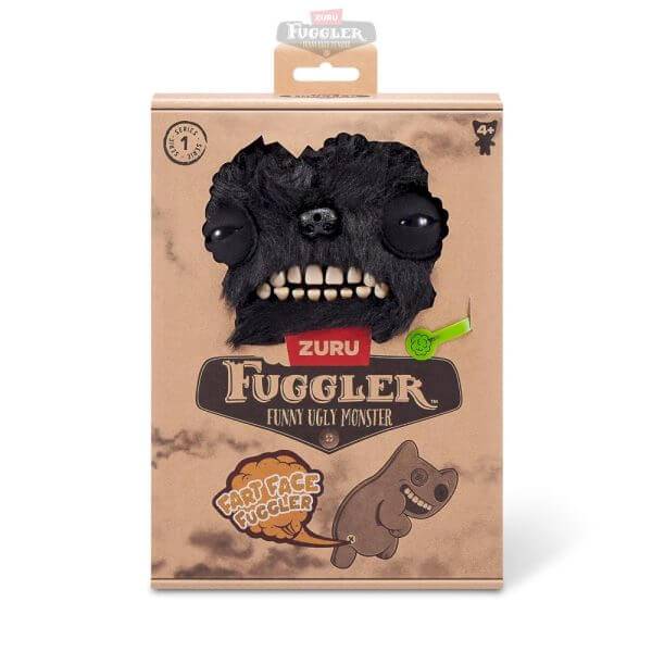 Verpacktes ZURU Fuggler Funny Ugly Monster Spielzeug mit schwarzem felderigem Monstergesicht, Zähnen und „Hard Face Fuggler" Etikett.