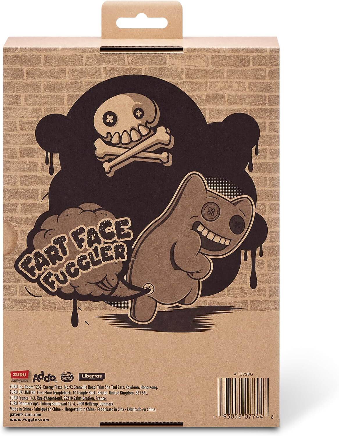 Verpackte "Fart Face Fuccler""-Spielzeuggrafik auf einer Kartonschachtel, die eine grinsende katzenähnliche Figur vor einer Totenkopf-und-Knochen-Wolke zeigt.