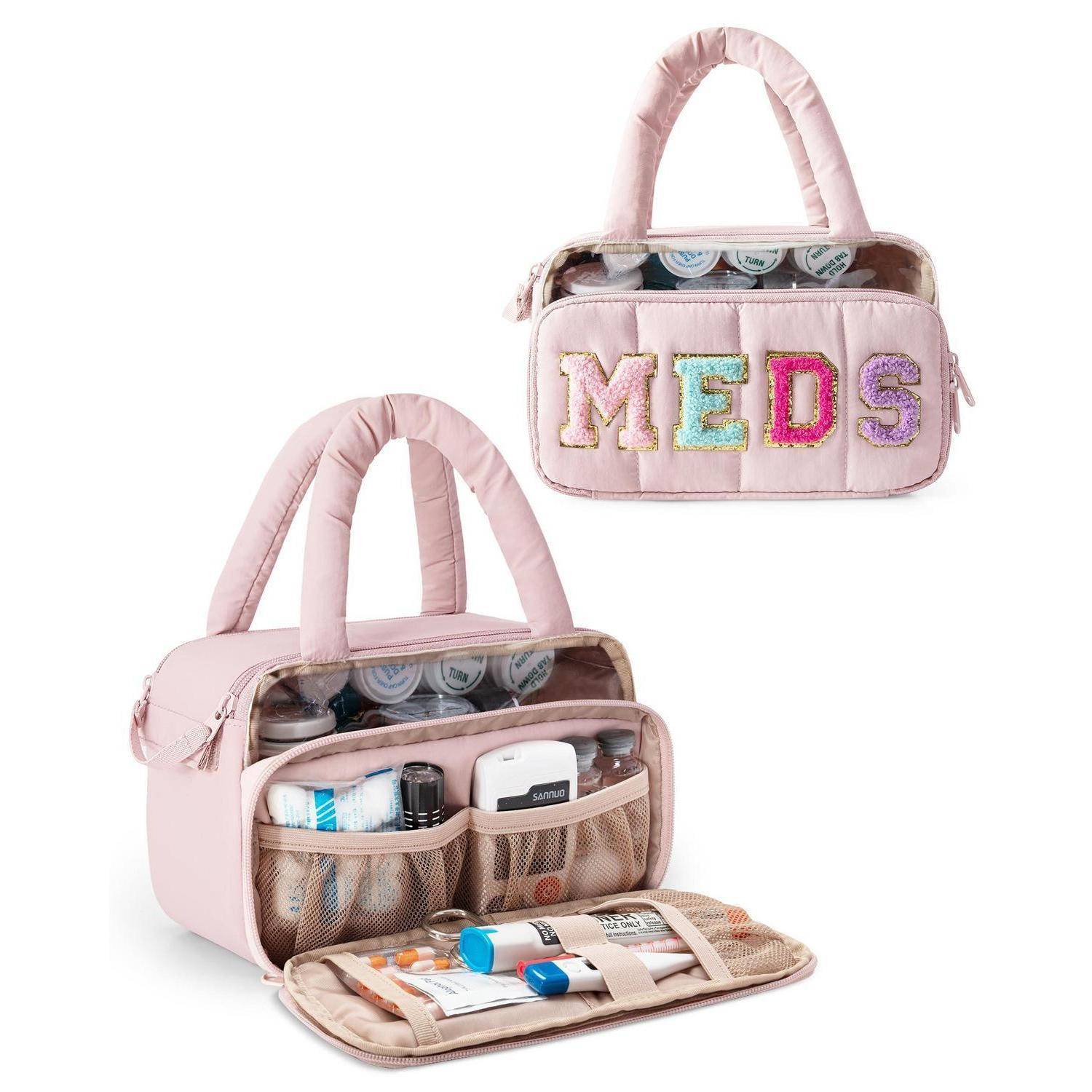 Rosa isolierte Medikamententasche mit Griff, Vordertasche und Netzfächern, geöffnet mit medizinischen Hilfsmitteln und „MEDS