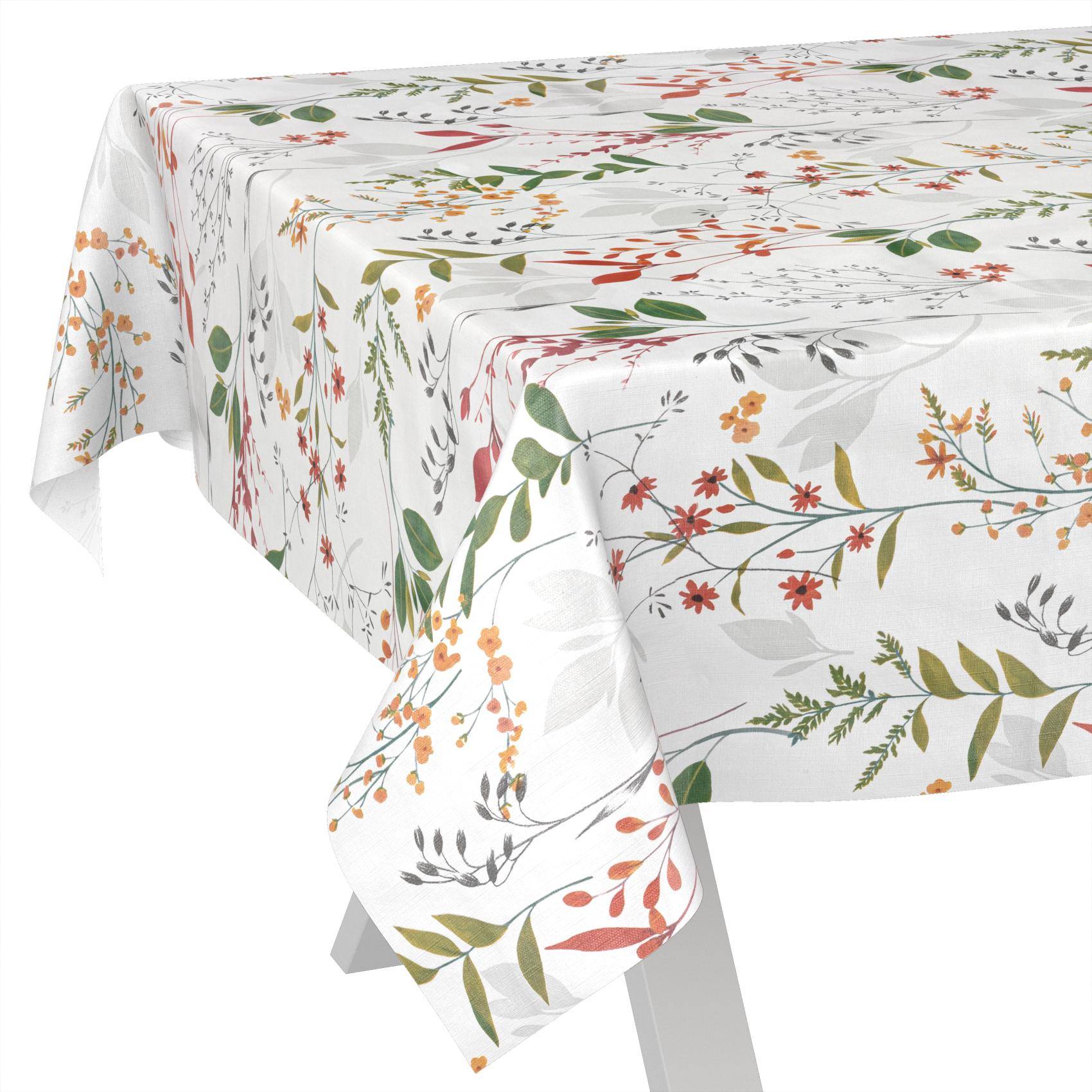 Weiße Tischdecke mit farbenfrohem Blumen- und Blatenmuster, über einem rechteckigen Tisch drapiert.
