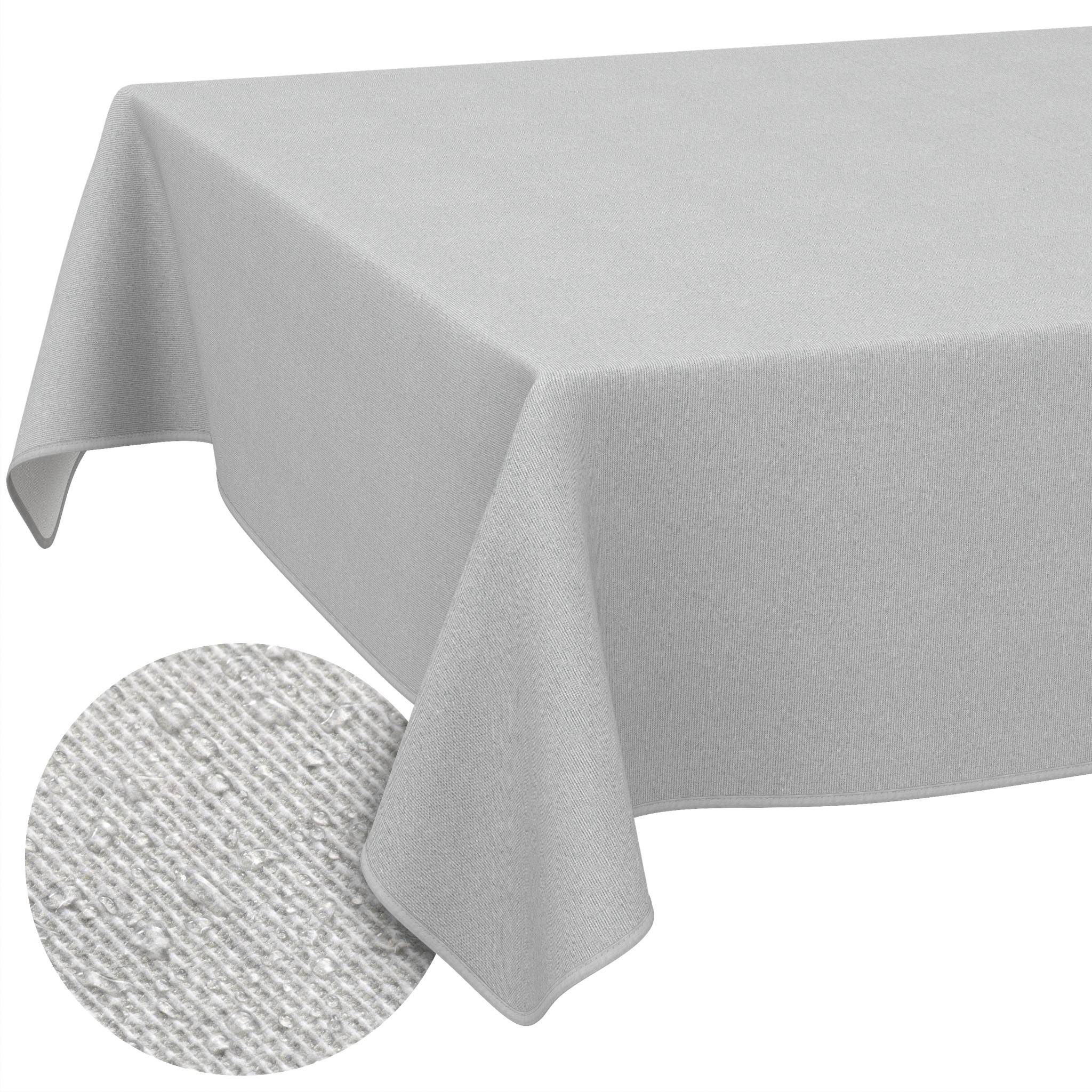 Graue Tischdecke, die über einen Tisch drapiert ist, mit einer kreisförmigen Nahaufnahme, die die Stofftextur zeigt.