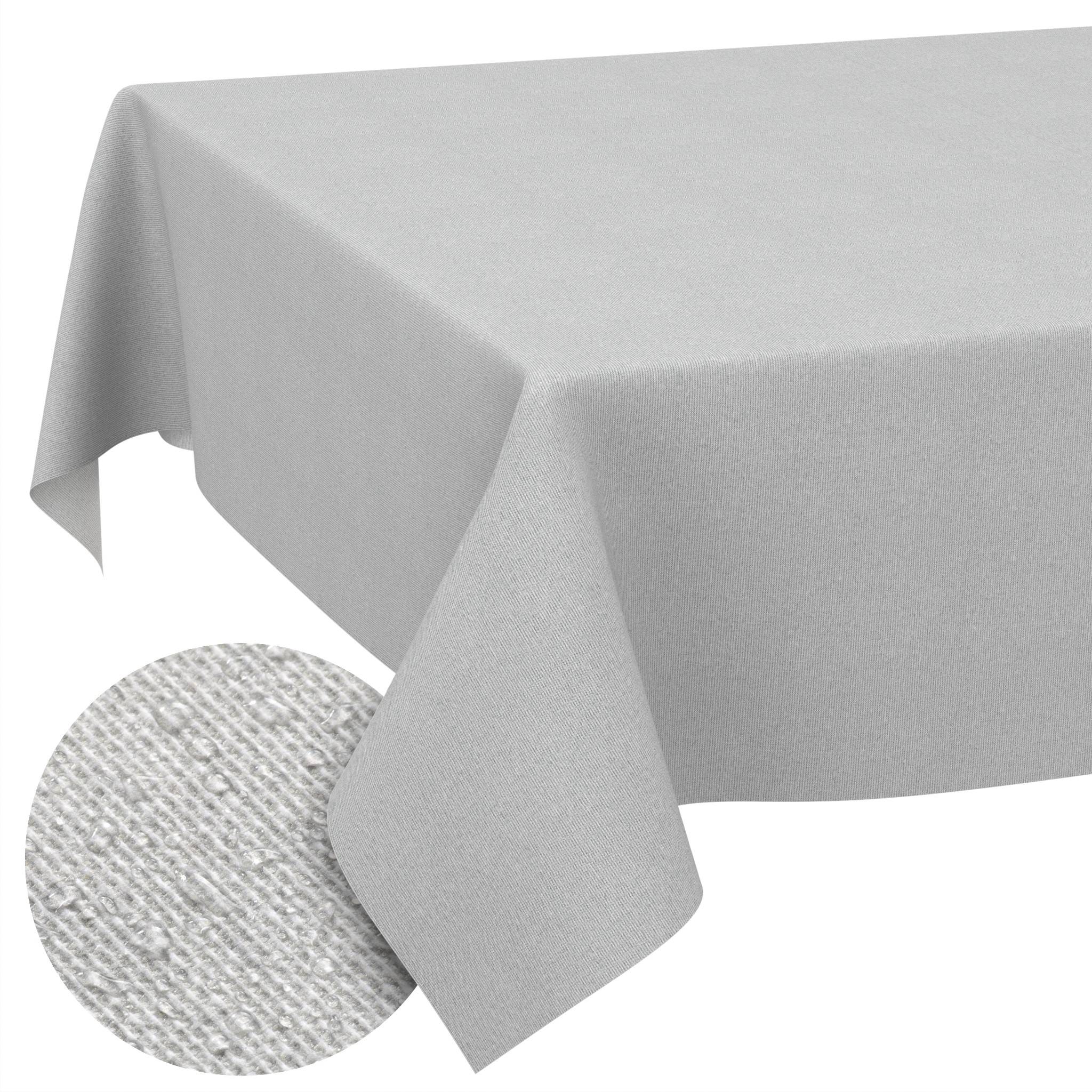 Graue Tischdecke über einem Tisch drapiert, mit einer teilweise sichtbaren runden strukturierten Platzdecke darunter.