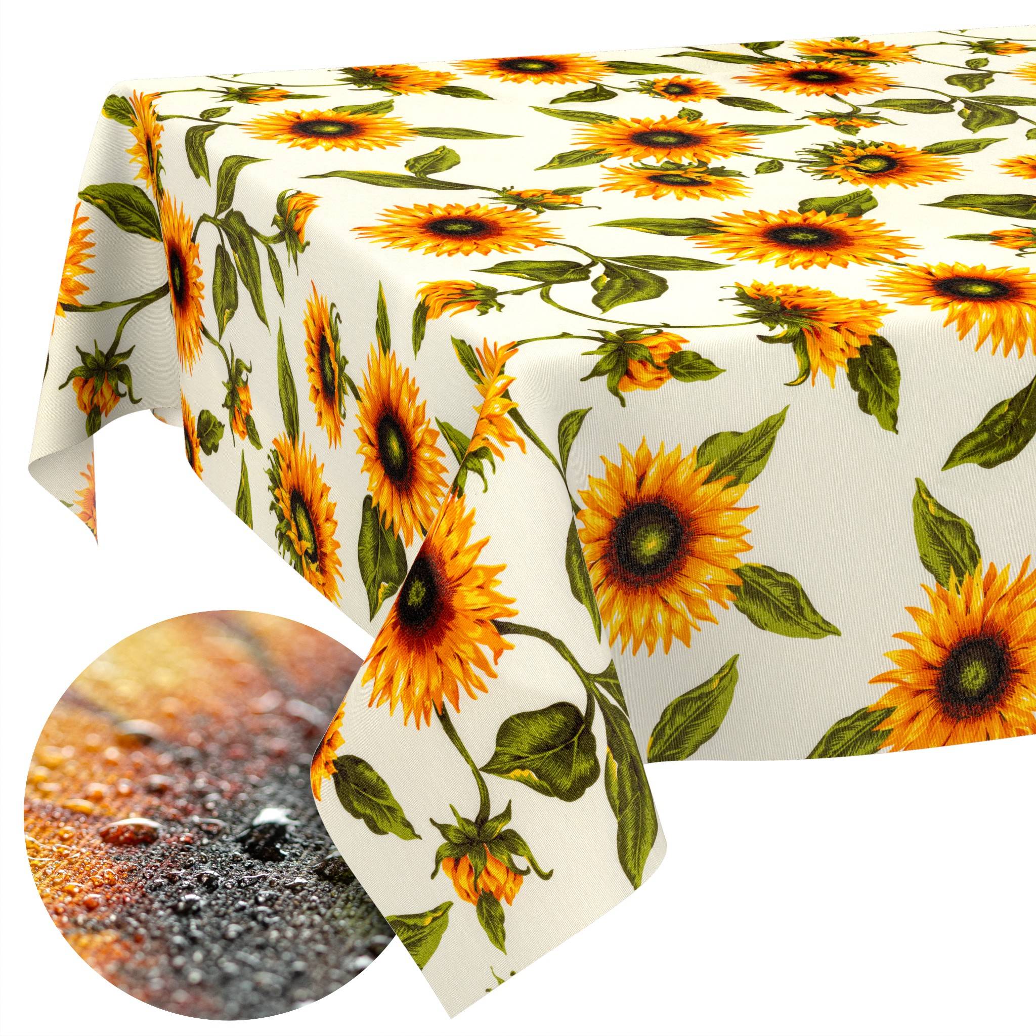 Sonnenblumenmuster-Tischtuch, das über einen Tisch drapiert ist, mit einer kreisförmigen Einfassung, die eine strukturierte, gefleckte Oberfläche darunter zeigt.