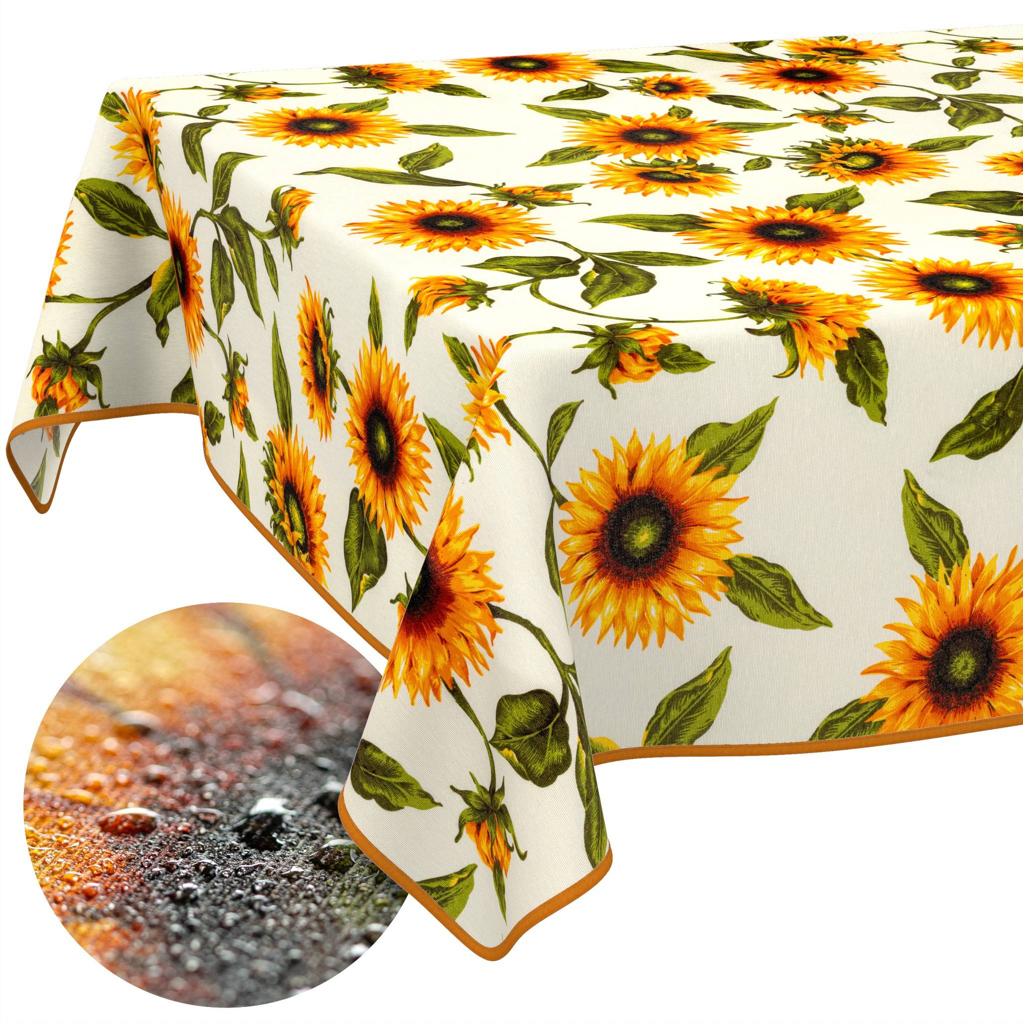 Tischdecke mit Sonnenblumenmuster und orangefarbener Borte, die über einem Tisch drapiert ist, mit einer Nahaufnahme ihres strukturierten Oberflächenmusters.