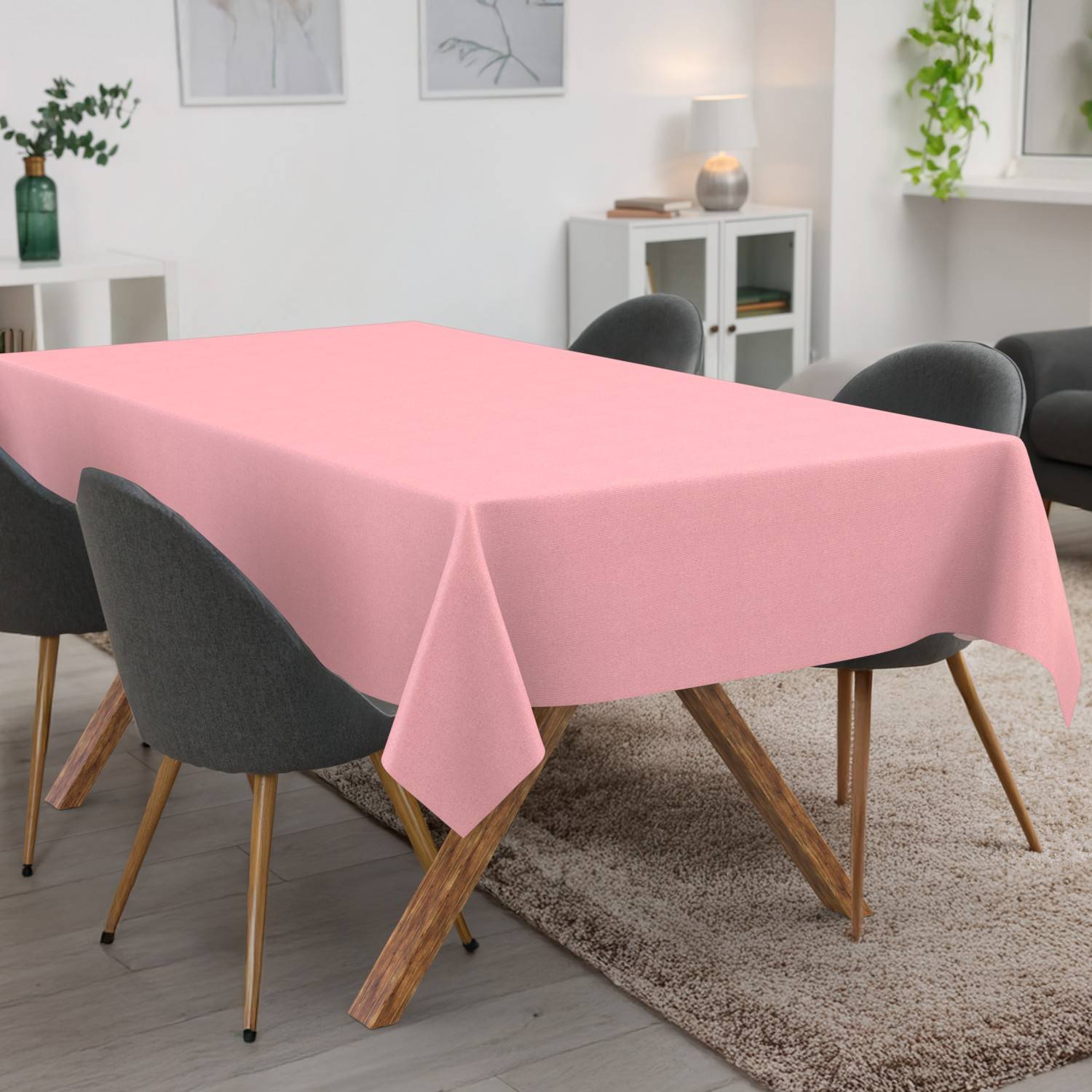 Rosa Tischdecke, die über einem rechteckigen Esstisch in einem modernen Esszimmer mit dunklen Stühlen drapiert ist.
