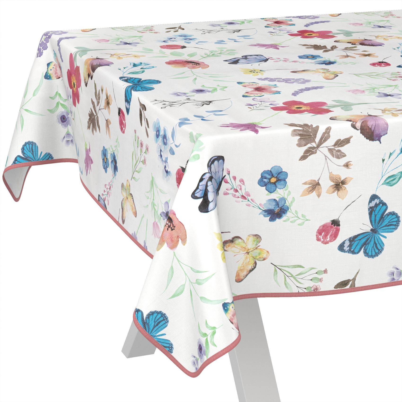 Tischdecke mit Schmetterings- und Blumenmuster, über einem rechteckigen Tisch drapiert, mit rosa Borte.