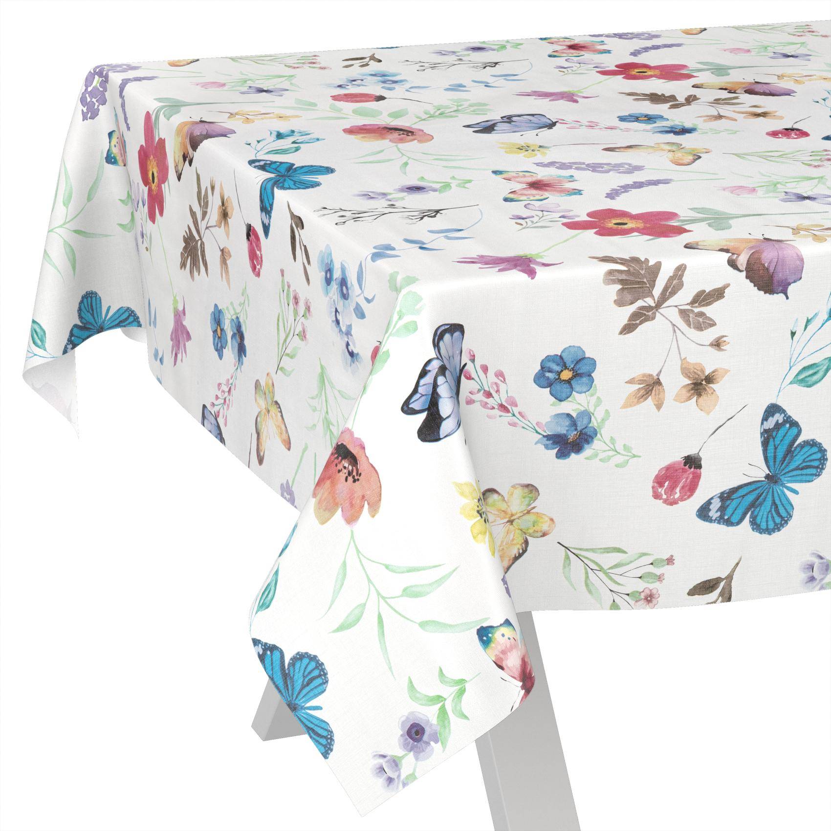 Weißes Tischtuch mit buntem Blumen- und Schmetterlingsdruck, das über einen rechteckigen Tisch drapiert ist.