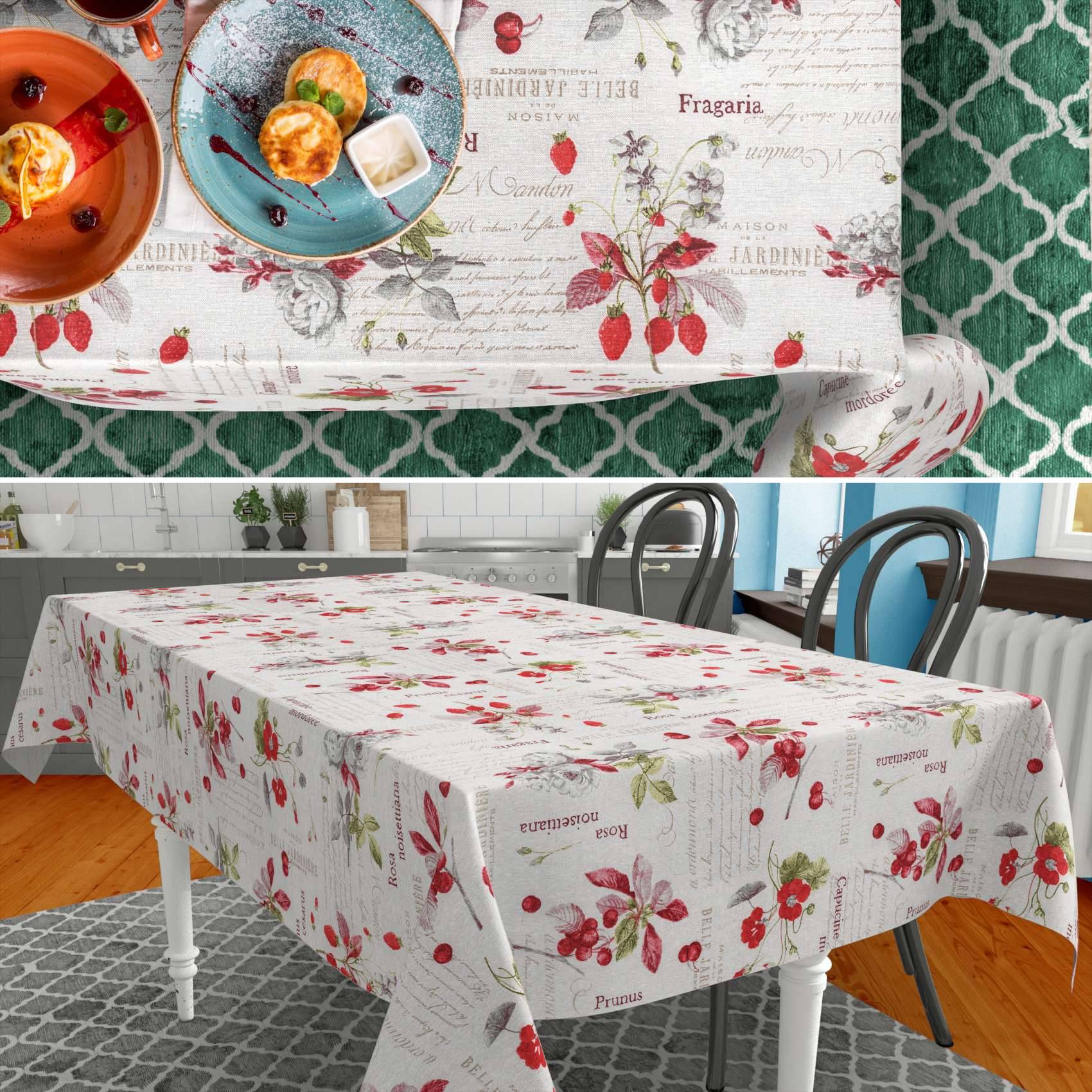 Tischdecke mit Erdbeermuster in Weiß mit roten Beeren und vintage Fruchttext, gezeigt auf einem Esstisch und in einer Nahaufnahme des Drucks.