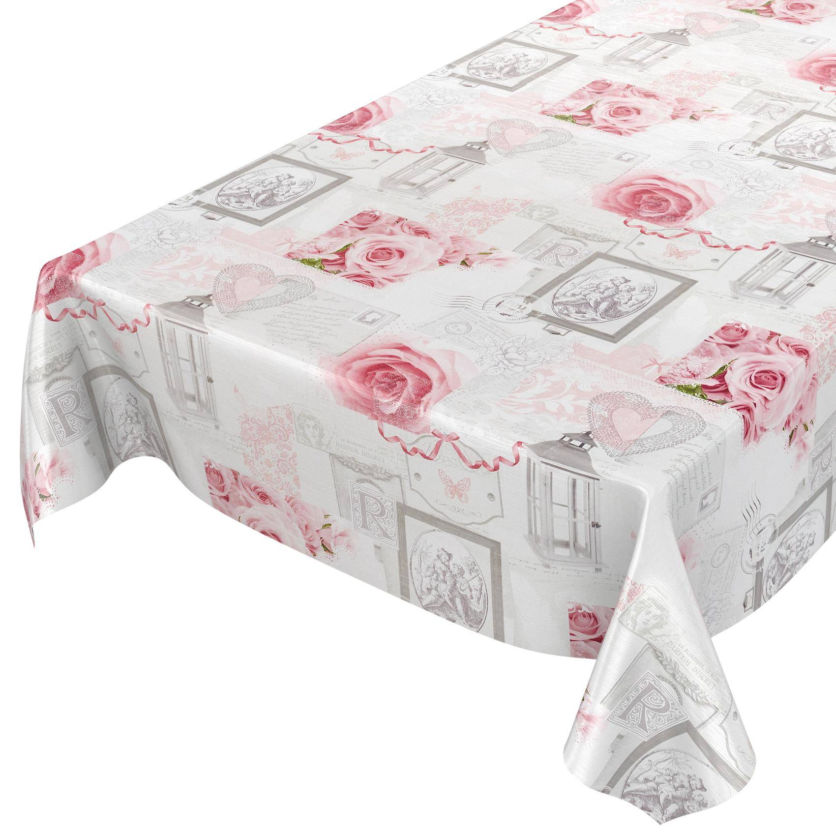 Tisch mit weißer Tischdecke, die mit rosa Rosen, Herzen und dekorativen grauen Rahmen gemustert ist.