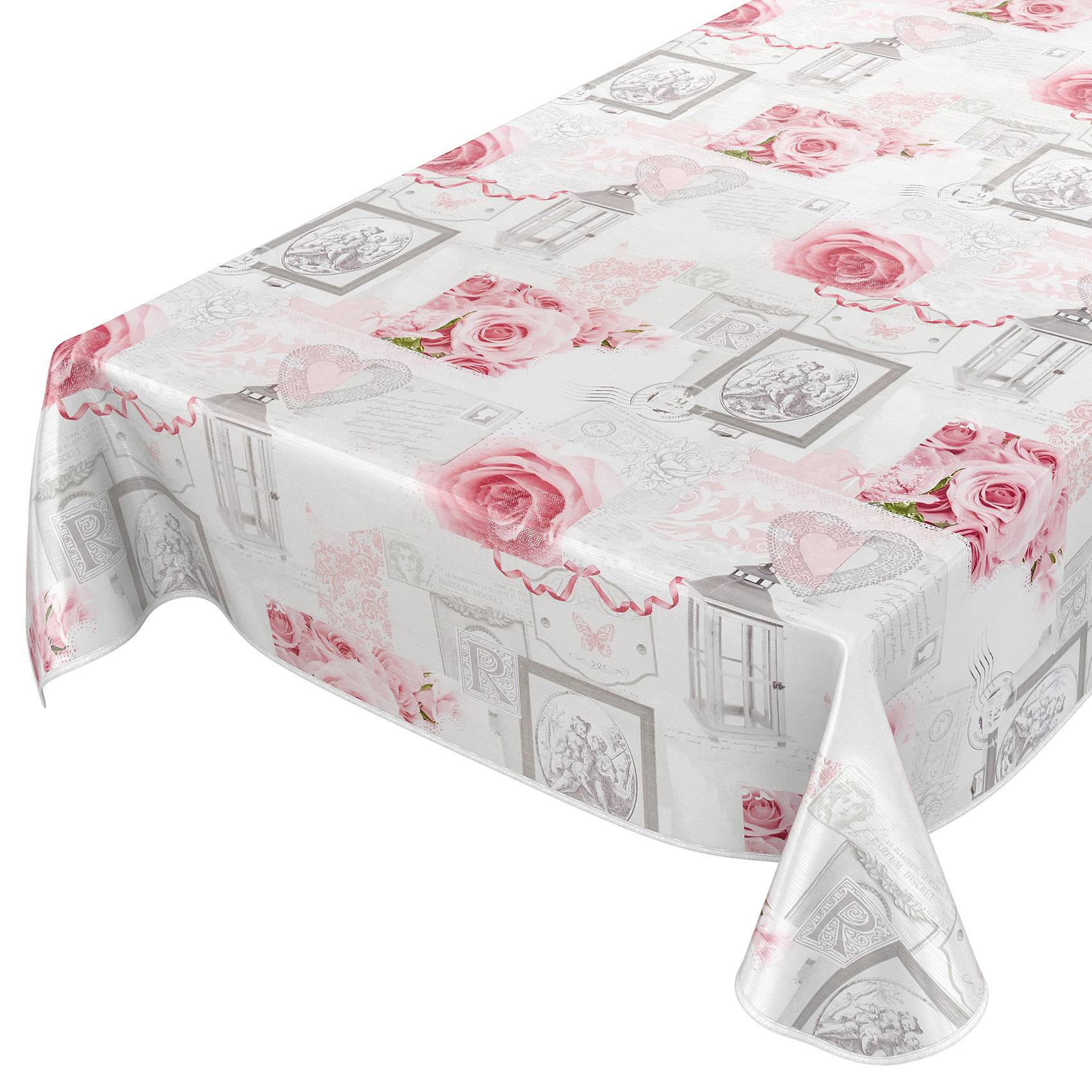 Ein rechteckiger Tisch, bedeckt mit einer weißen Kunststofftischdecke, bedruckt mit rosa Rosen, Herzen und Rahmen im Vintage-Stil.