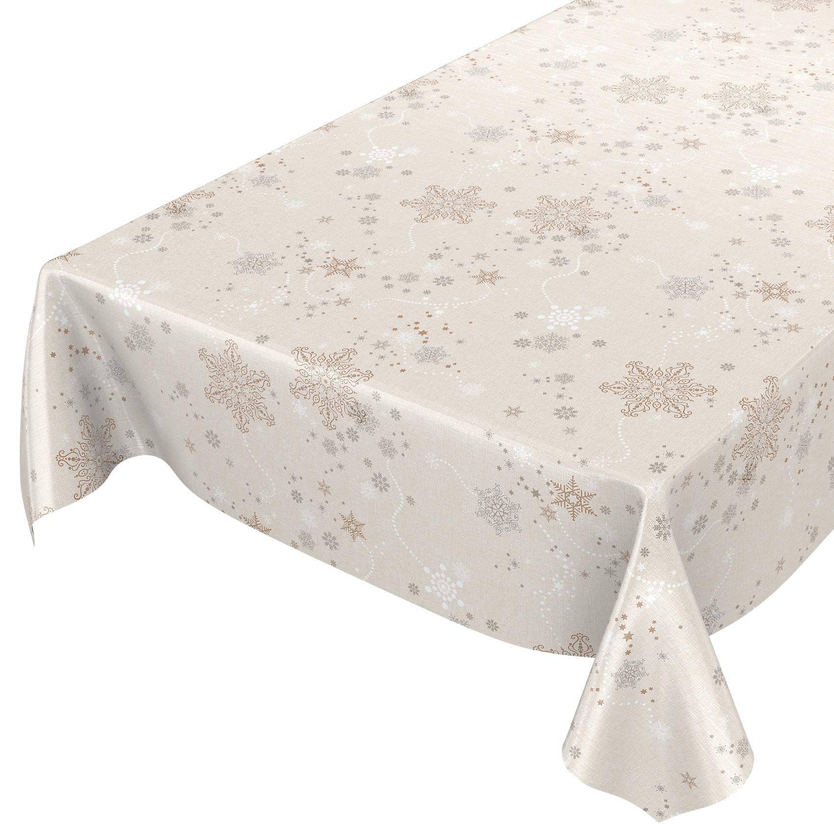 Hellbeige Tischdecke mit subtilen Gold- und Silber-Schneeflocken-Muster, das über einen rechteckigen Tisch drapiert ist.