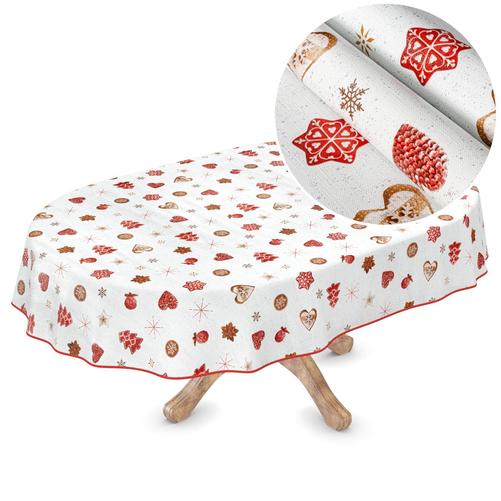 Ein runder Tisch mit einer weißen, festlich gestalteten Tischdecke, die mit roten und goldenen Weihnachtsmotiven gemustert ist, dargestellt mit einer Nahaufnahme des Stoffdrucks.