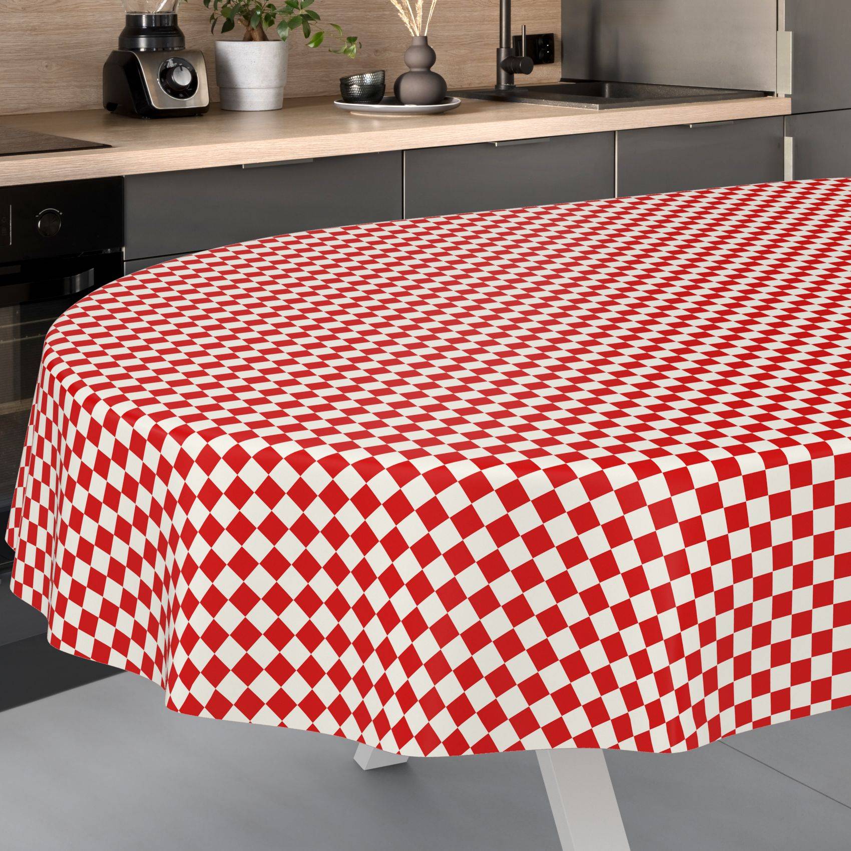 Ein runder Tisch mit einer rot-weiß karierten Tischdecke mit Rautenmuster in einer modernen Küche.