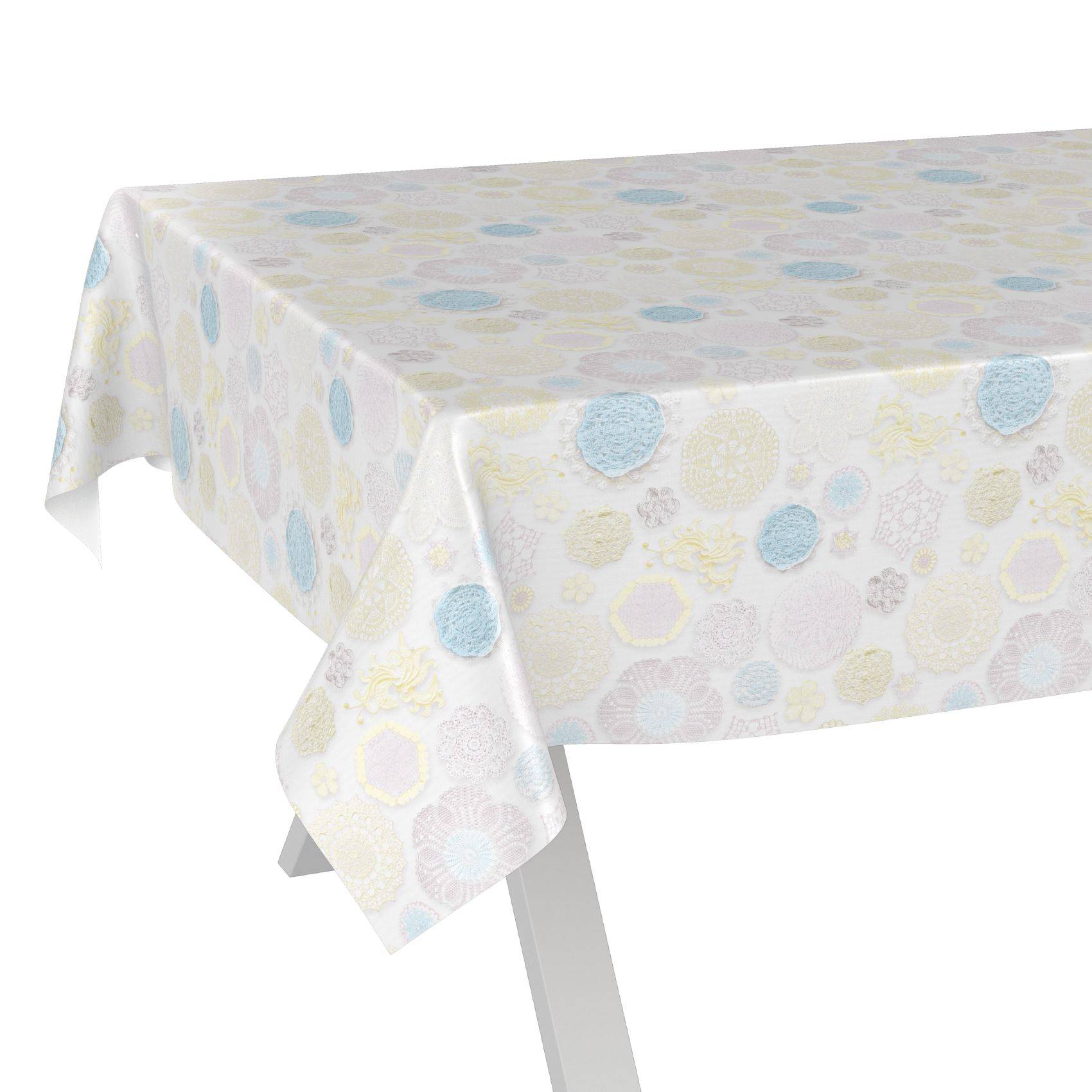 Tisch mit einer Tischdecke in Pastellmuster, die blasse blaue, gelbe und weiße kreisförmige Designs aufweist.