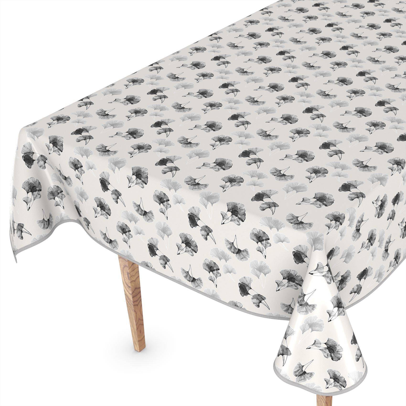 Tisch mit einer weißen Tischdecke mit Blumenmuster, die über die Kanten drapiert ist und auf einem Tisch mit Holzbeinen gezeigt wird.