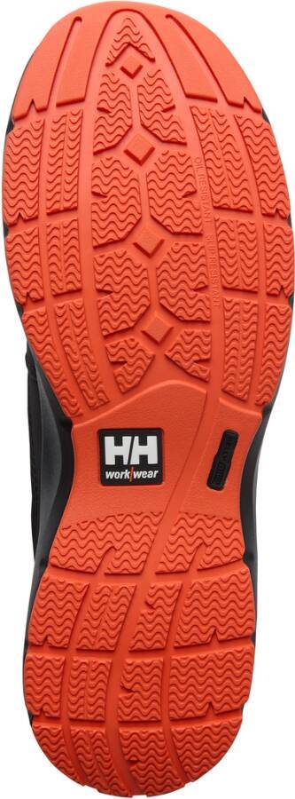 Orange und schwarze Helly Hansen Arbeitsschuh-Laufsohle von unten gezeigt, mit tiefem Profilmuster und "HH workwear"" Logo.