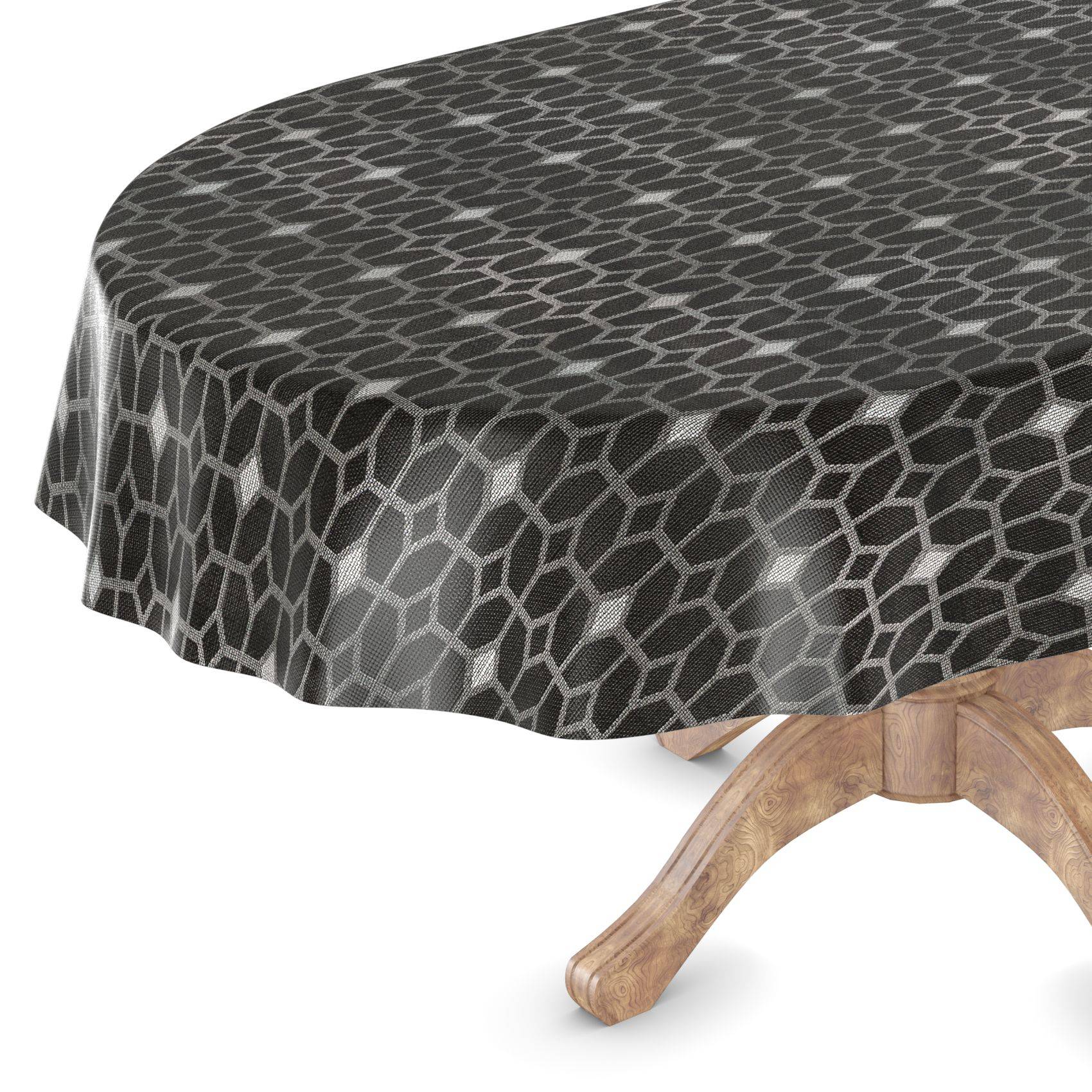 Runder Tisch mit einer schwarzen geometrisch gemusterten Tischdecke, darunter ist ein Teil des hölzernen Sockels sichtbar.