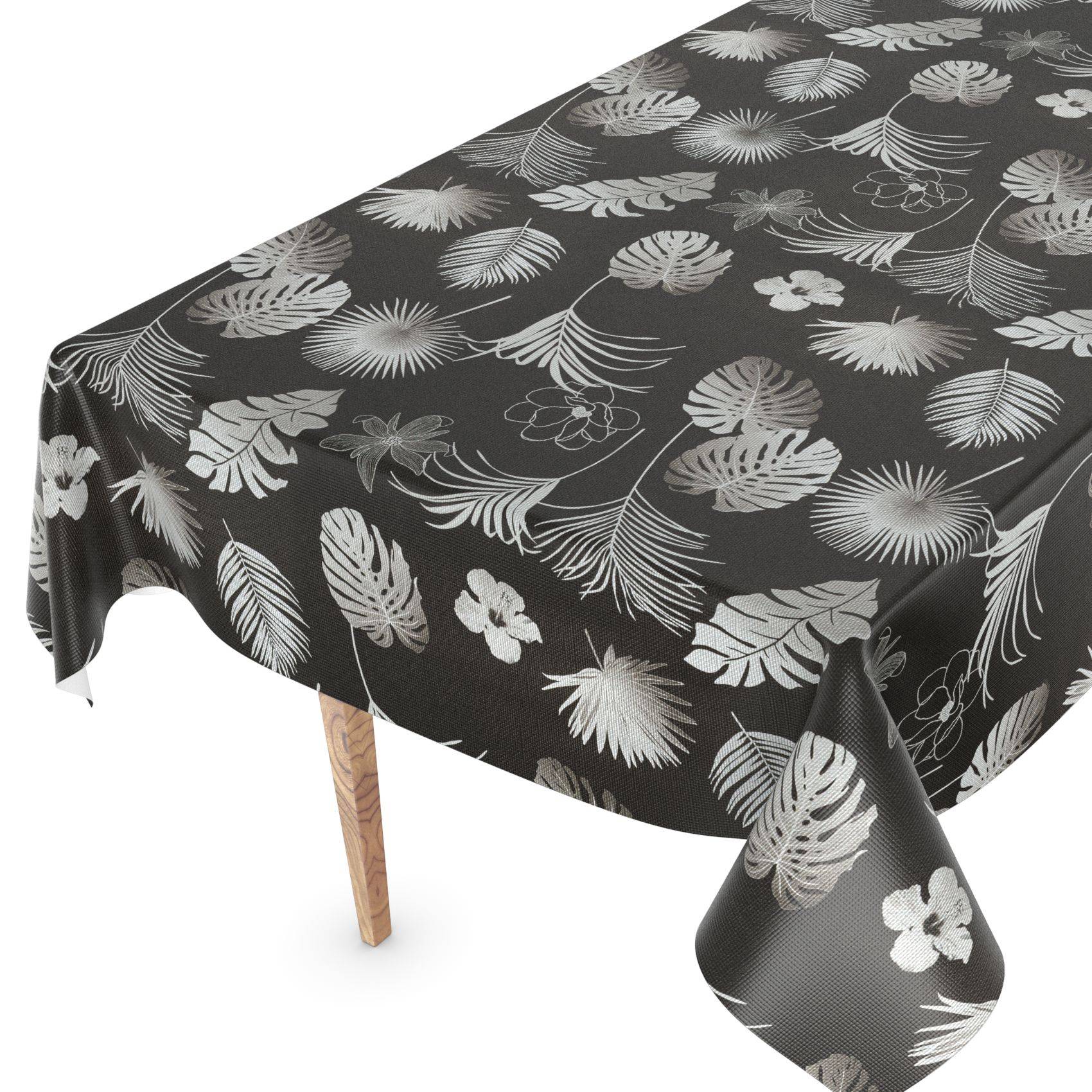 Schwarze Tischdecke mit weißem tropischem Blatt- und Blumenmuster, drapiert über einen Tisch mit Holzbeinen.