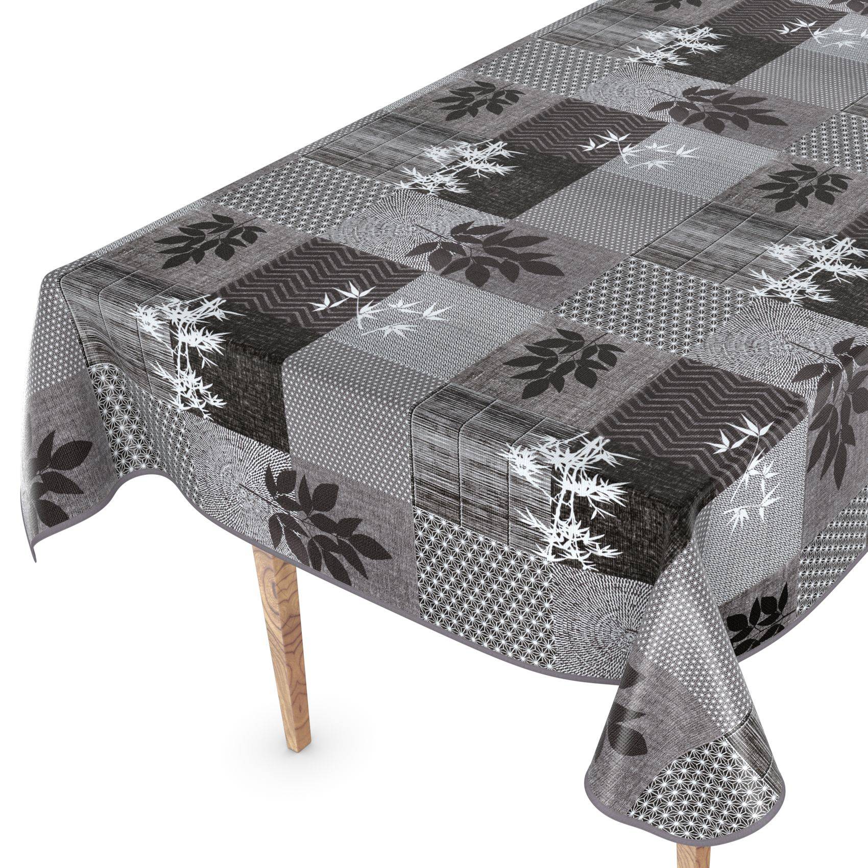 Grau kariertes Patchwork-Tischtuch mit Blatt- und Schneeflockenmuster über einem Tisch drapiert, zeigt eine Muschelkante und ein Holzbein.
