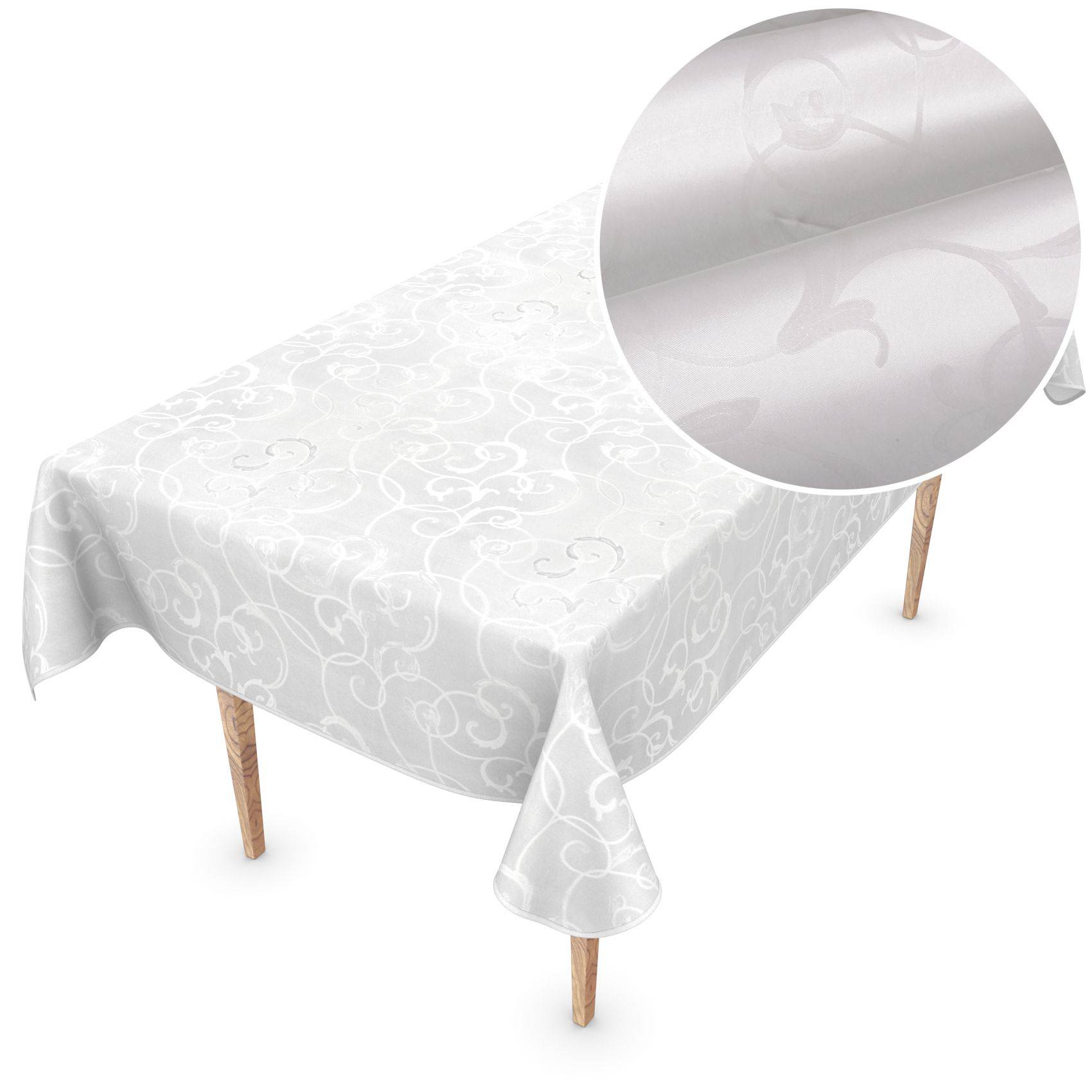 Weiße gemusterte Tischdecke über einem rechteckigen Tisch drapiert, mit einer kreisförmigen Vergrößerung, die die subtile geprägte Textur des Stoffs zeigt.