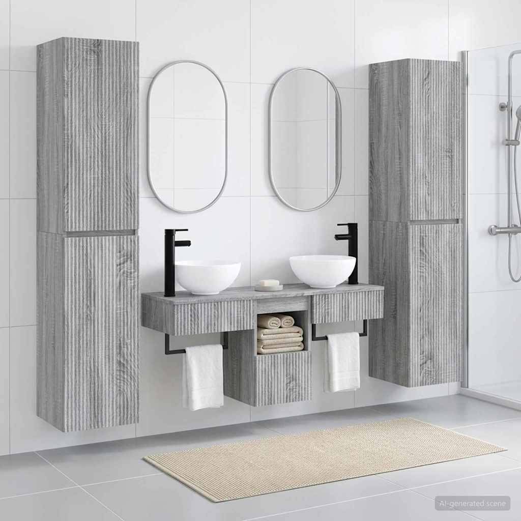Modernes Badezimmer mit Doppelwaschbecken, ovalen Spiegeln, hohen grauen Schranksäulen, weißen Waschbecken und einer Dusche, die auf der rechten Seite sichtbar ist.