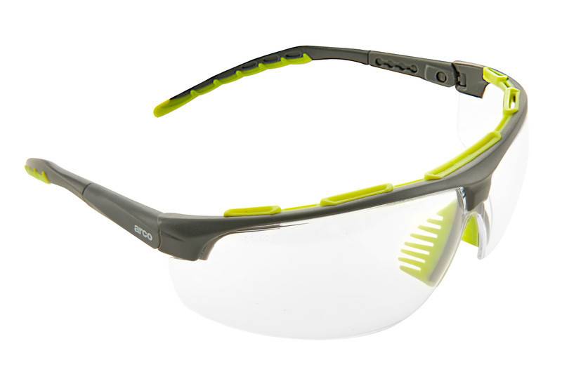 Umschließende Schutzbrille mit klaren Gläsern und grauen Rahmen mit neongrünen Akzenten, vor weißem Hintergrund abgebildet.