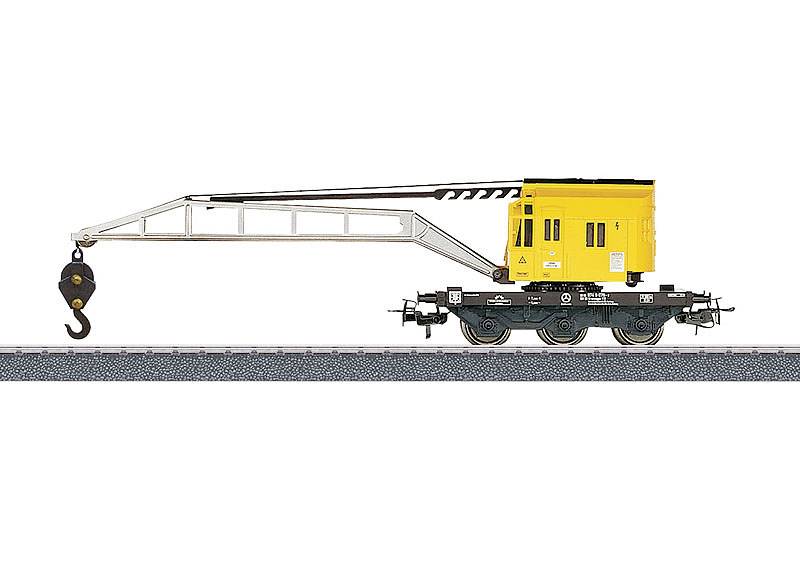 A yellow railway crane on tracks, featuring a long arm with a hook, used for lifting heavy objects.