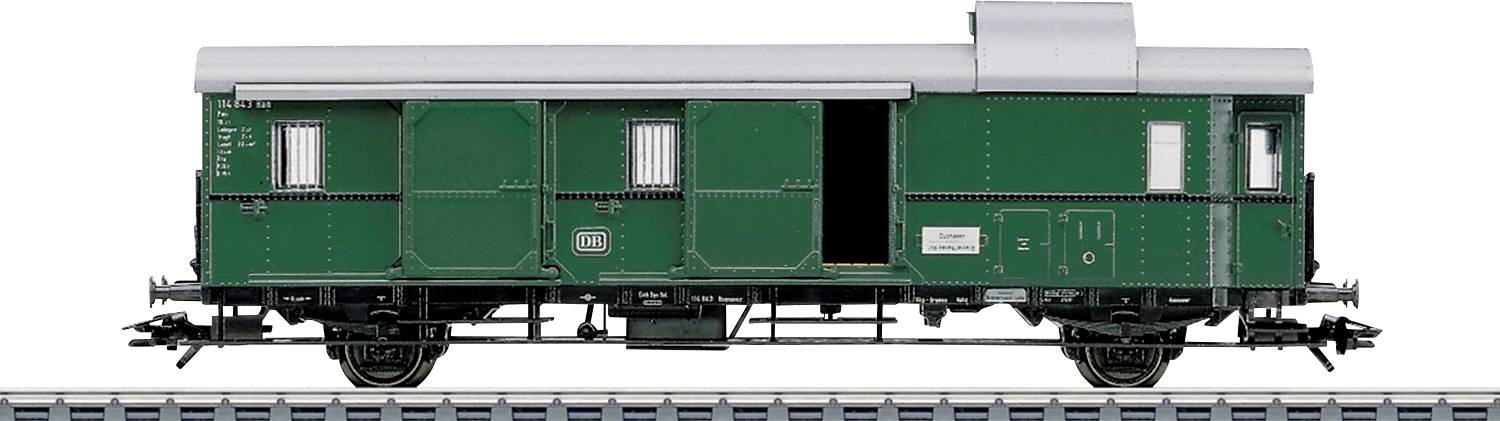 A green freight wagon is standing on a railway track. The wagon model has an open door on the right side and several ventilation slots.