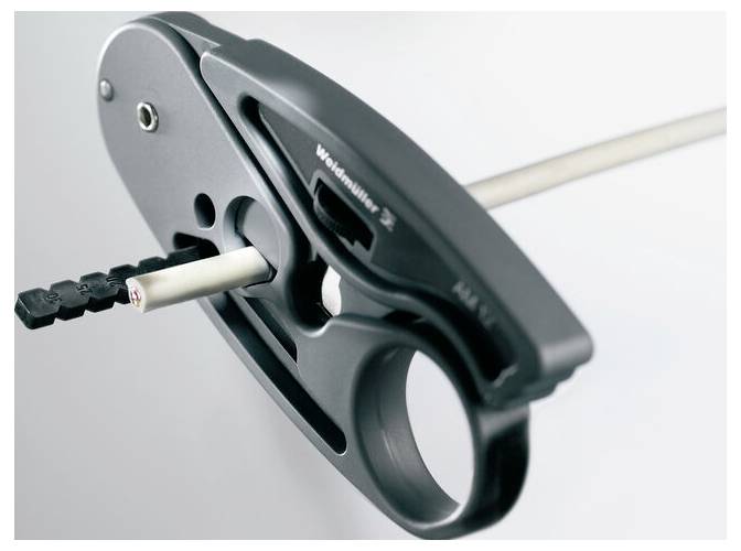 A tool used for inserting an object into a tube, featuring a lever mechanism and a sleek, ergonomic design for precise handling.