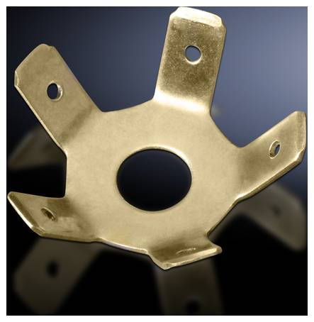 Metal part with five angled tabs and a central hole, against a dark blue background.