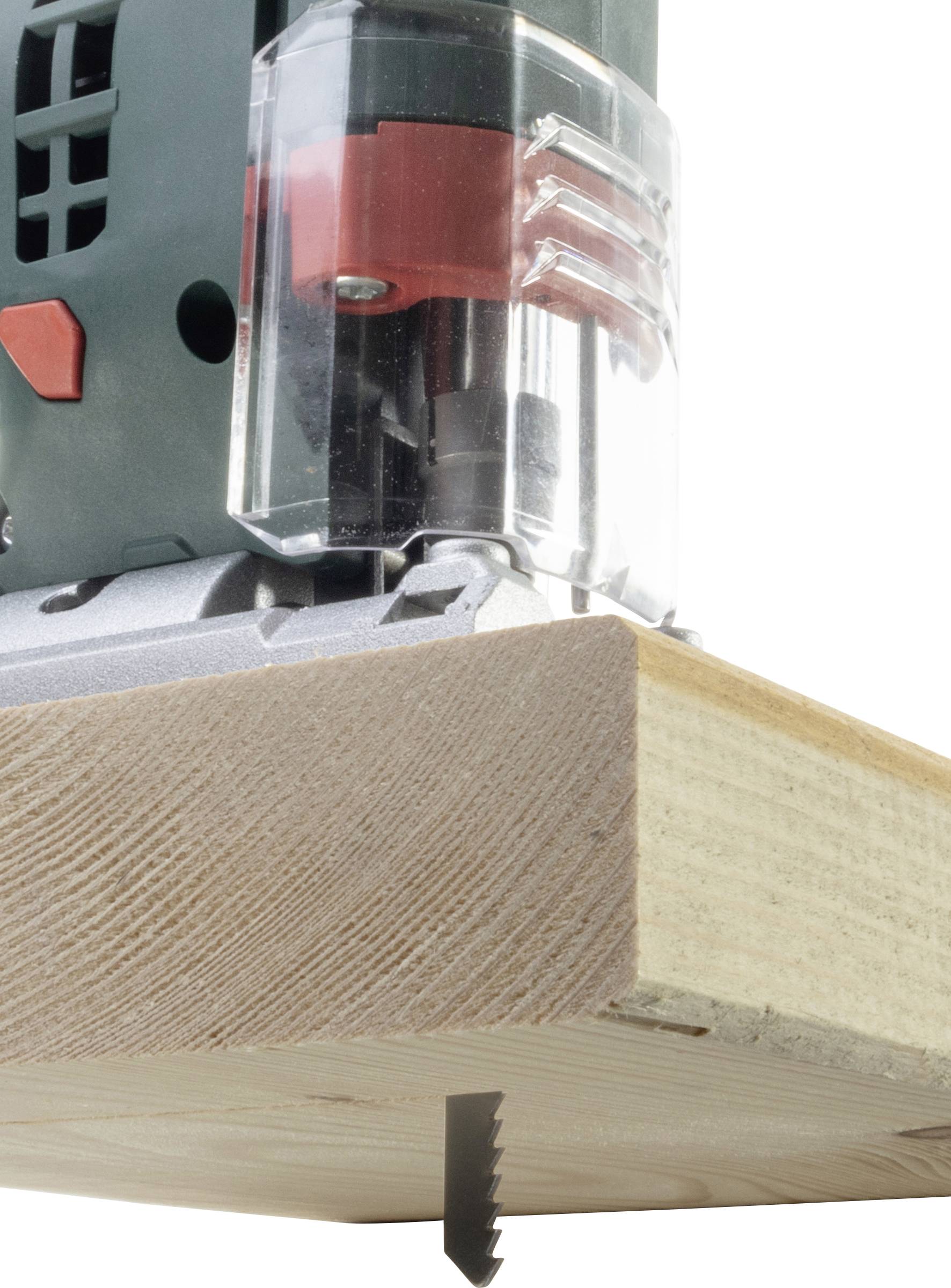 Close-up of an electric jigsaw cutting vertically through a wooden board. The saw blade is partially visible through the cut.