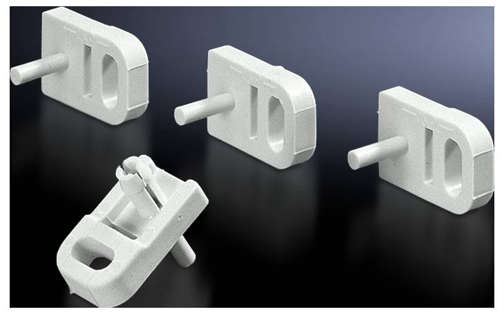 Four white, rectangular plastic components with central openings and protruding pins extend to the side. Another view shows a component lying sideways.