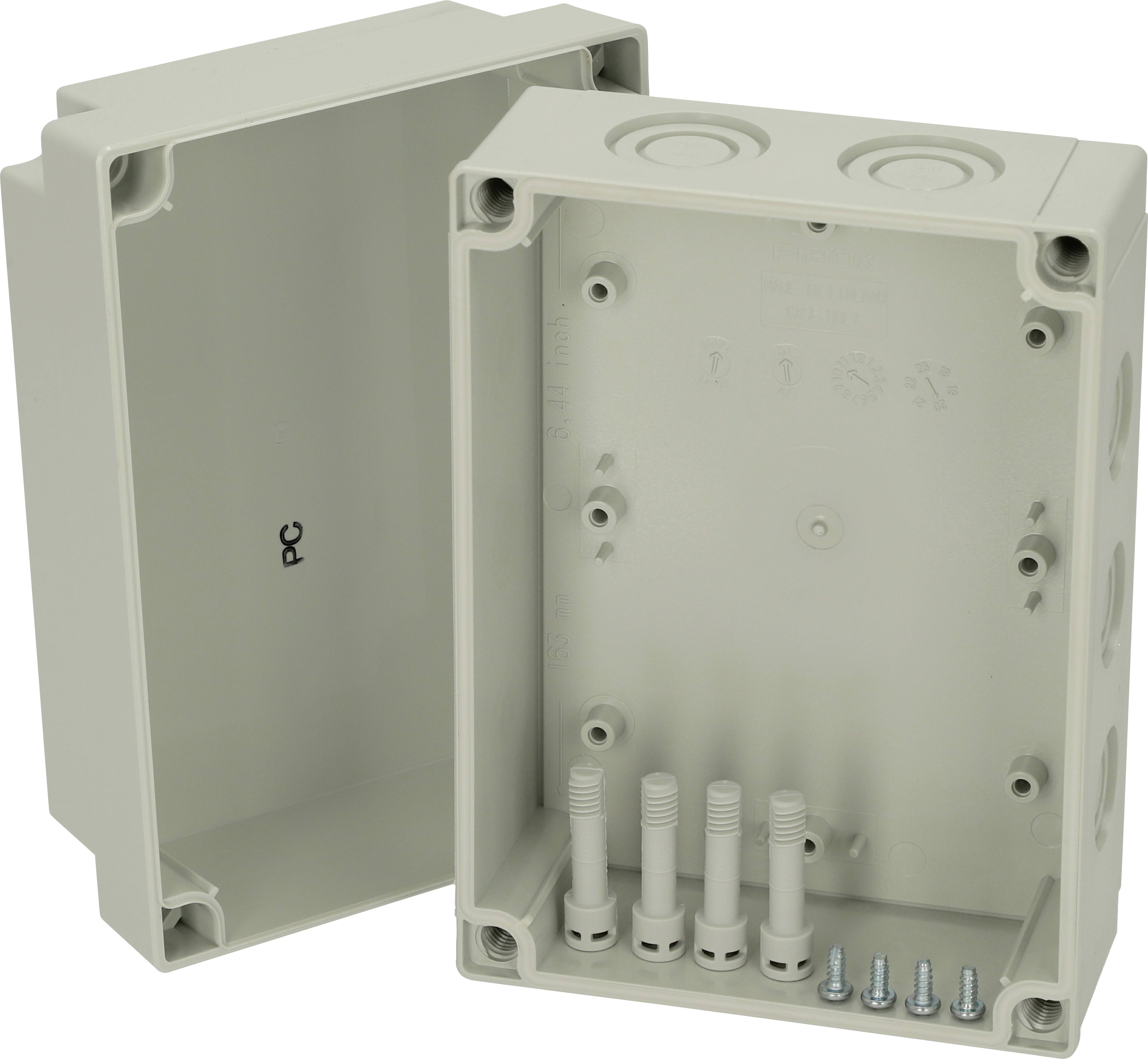 Plastic housing, rectangular, positioned without cover in the centre, with screws and openings for cable entry.