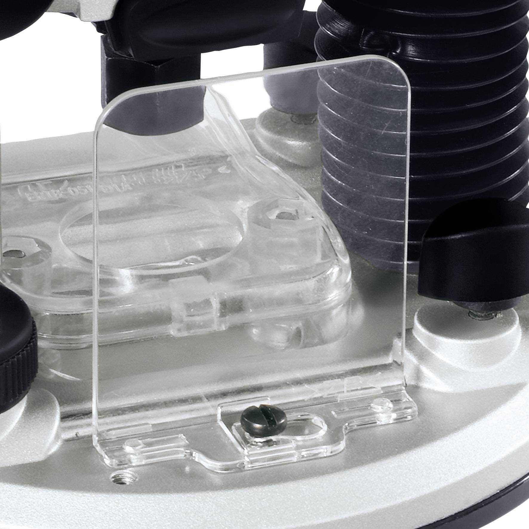 Close-up of a transparent chain guard, mounted on a bicycle component. The guard covers the chain area to ensure safety.