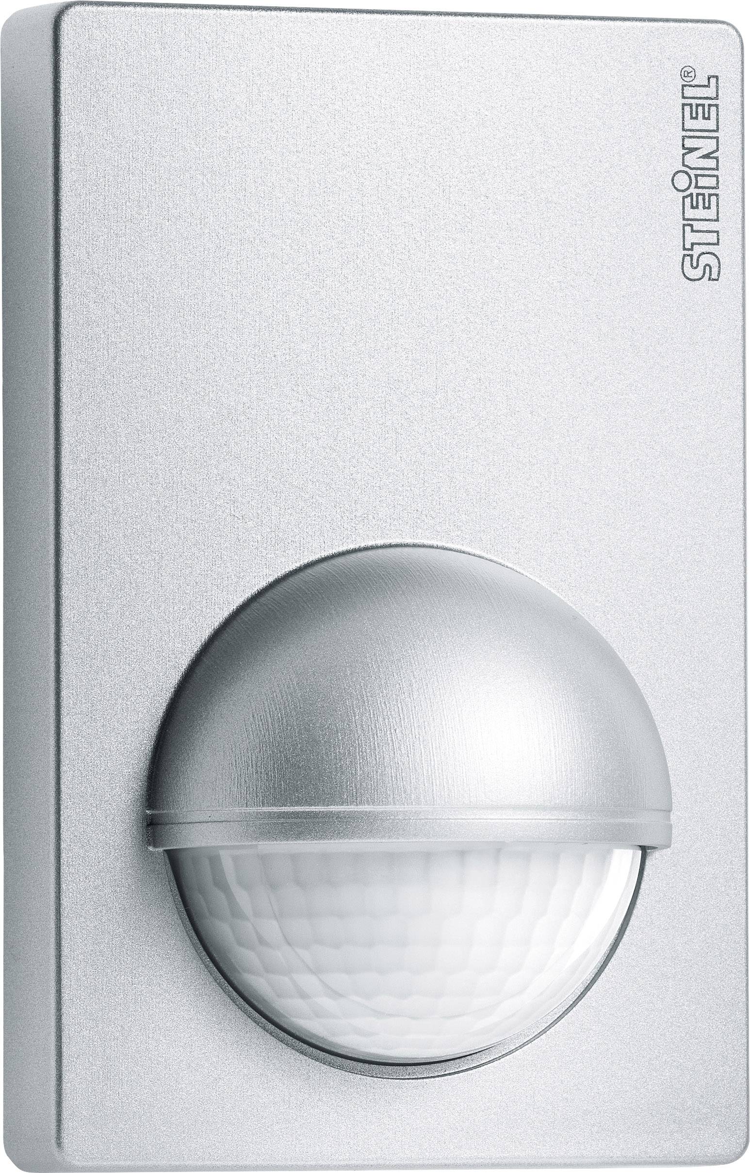A silver motion sensor with a rounded cap mounted on a wall, used for lighting detection or security.