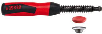 Red and black mechanical device with a spring-loaded black tip, shown with two small circular parts below it.