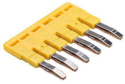 A yellow bridge plug with five metallic contacts, used for electrical connections in control cabinets.