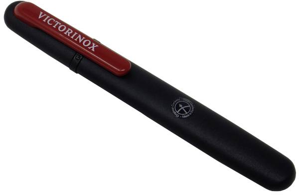 A black pen with a red clip, bearing the 'VICTORINOX' logo, is resting on a white surface.