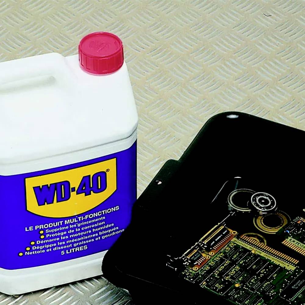 A WD-40 container next to a box of electronic components on a metallic background.