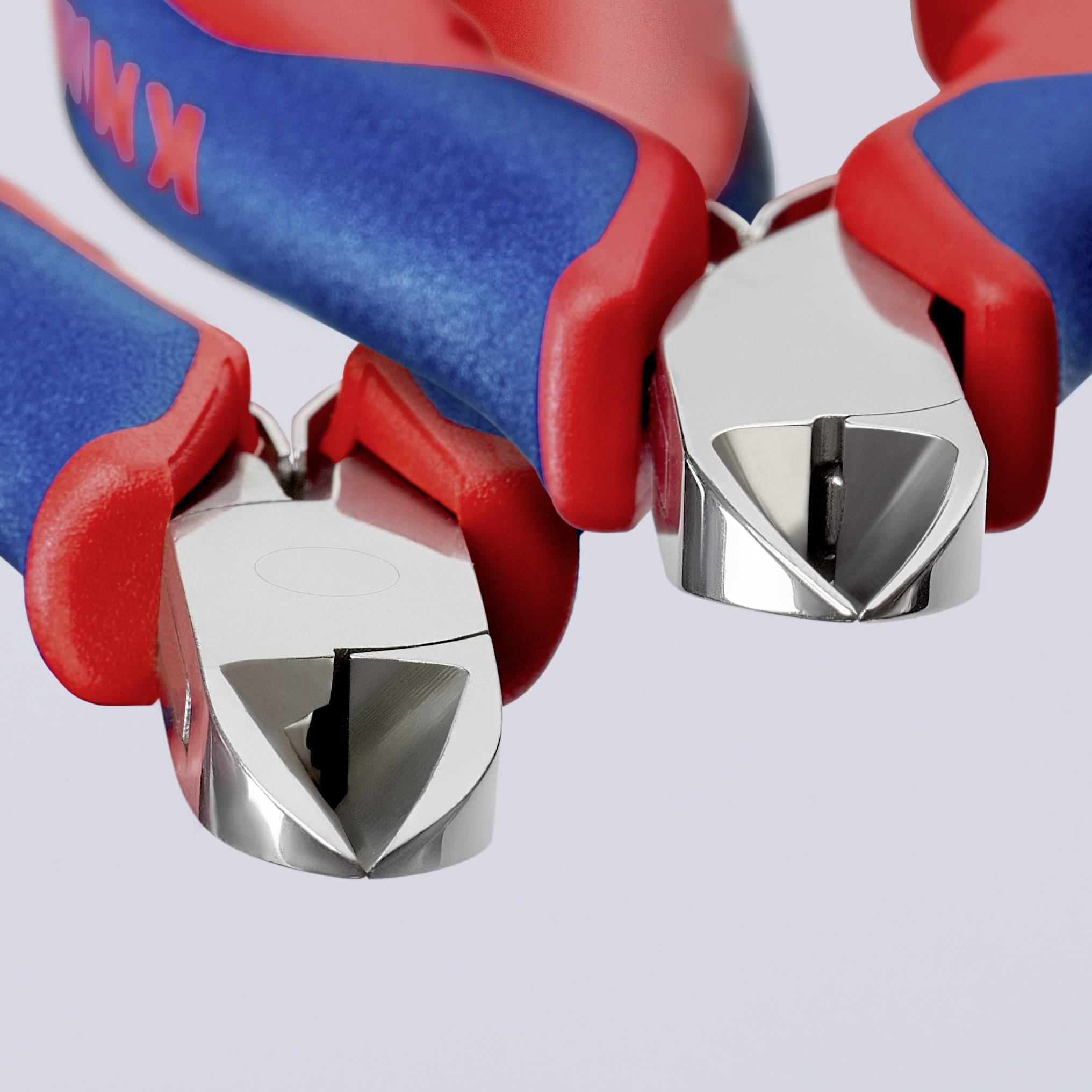 Two red and blue side cutters with shiny metal tips, lying side by side.