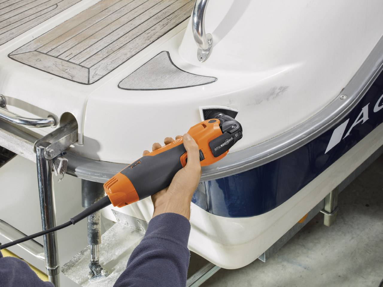 A person is working on a boat using an electric tool to remove scratches. The work process focuses on yacht maintenance, with an emphasis on rust removal.