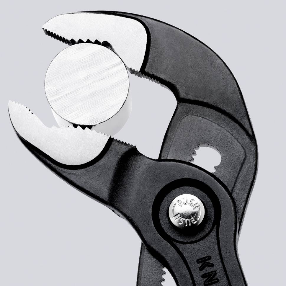 A black water pump pliers grips a round white object. It is slightly opened to hold the object securely.