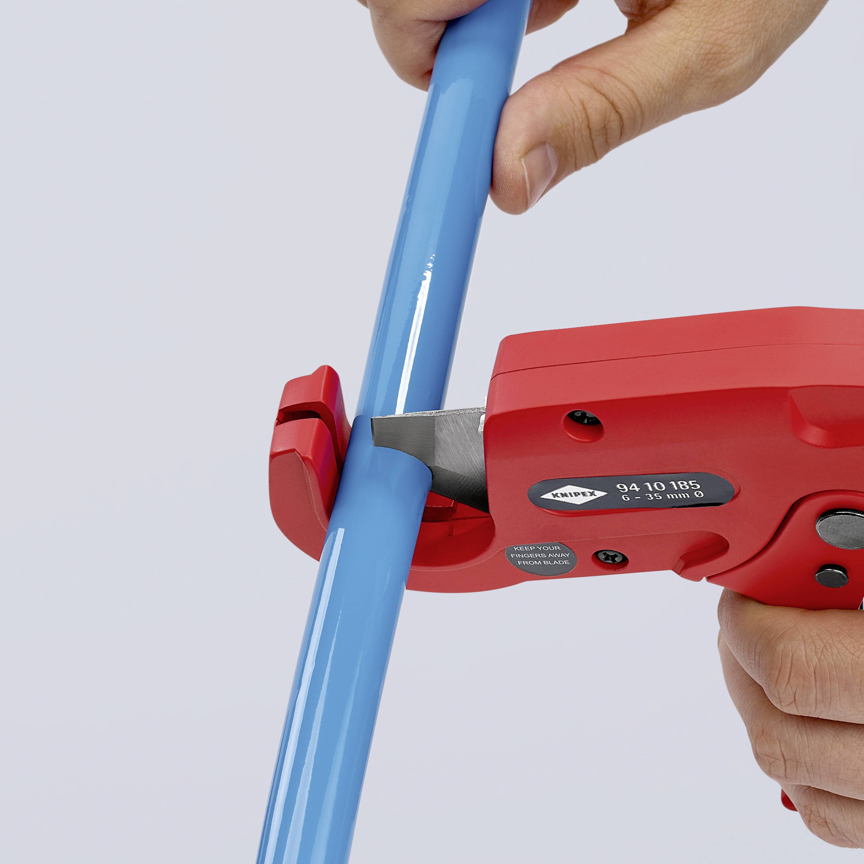 A hand is using a red tool to measure a long, blue pipe. The tool displays a scale and measurement values.