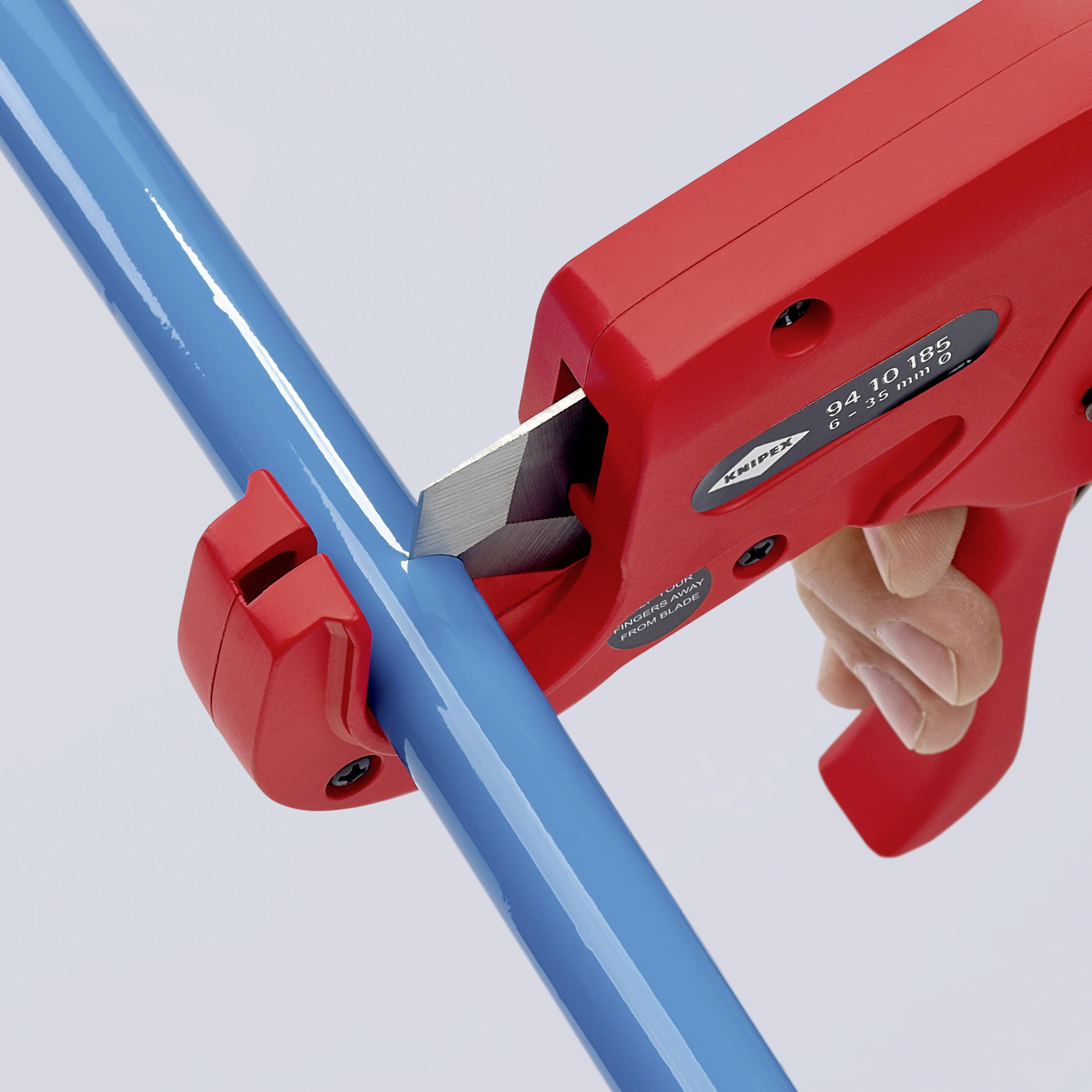A person is cutting a blue plastic pipe with a red pipe cutter. The pipe cutter has an ergonomic handle.