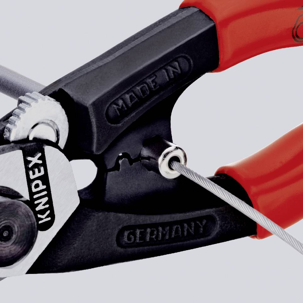A close-up of a red screwdriver with the inscription 'Knipex', 'Made in Germany'.