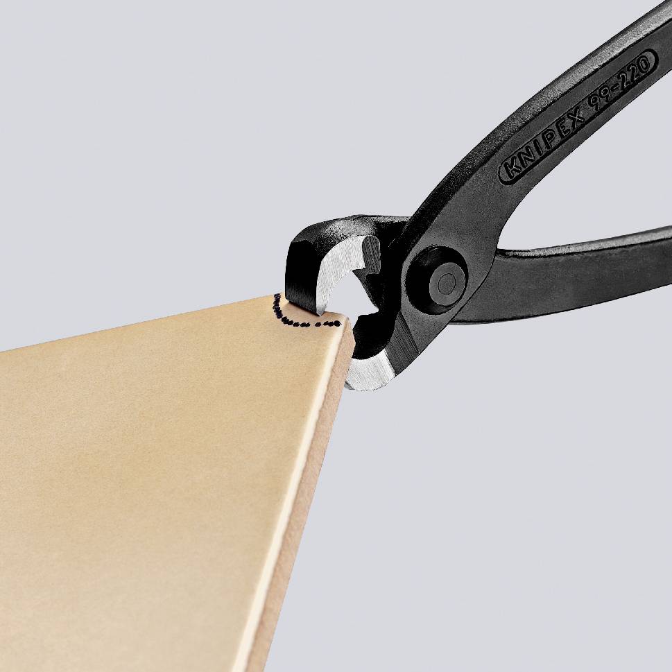 The scalpel cuts precisely through a thin, brown material. The marking line indicates the cutting path. The tool appears high-quality and robust.