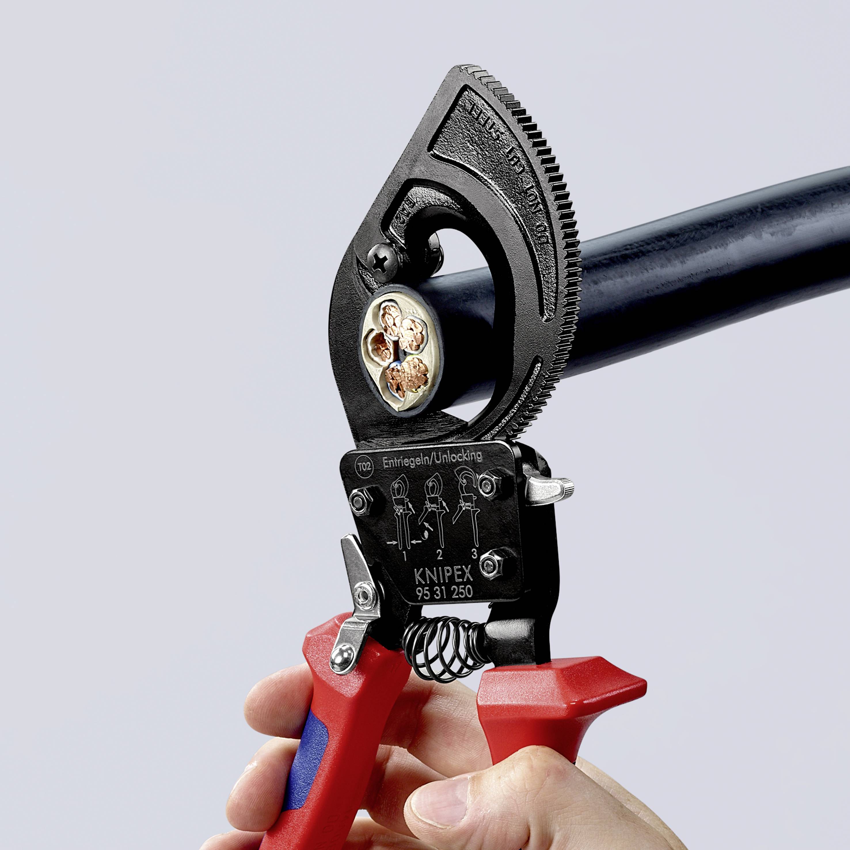 A person is holding an adjustable spanner gripping a black pipe. The spanner is partially red and has serrated teeth for a firm grip.