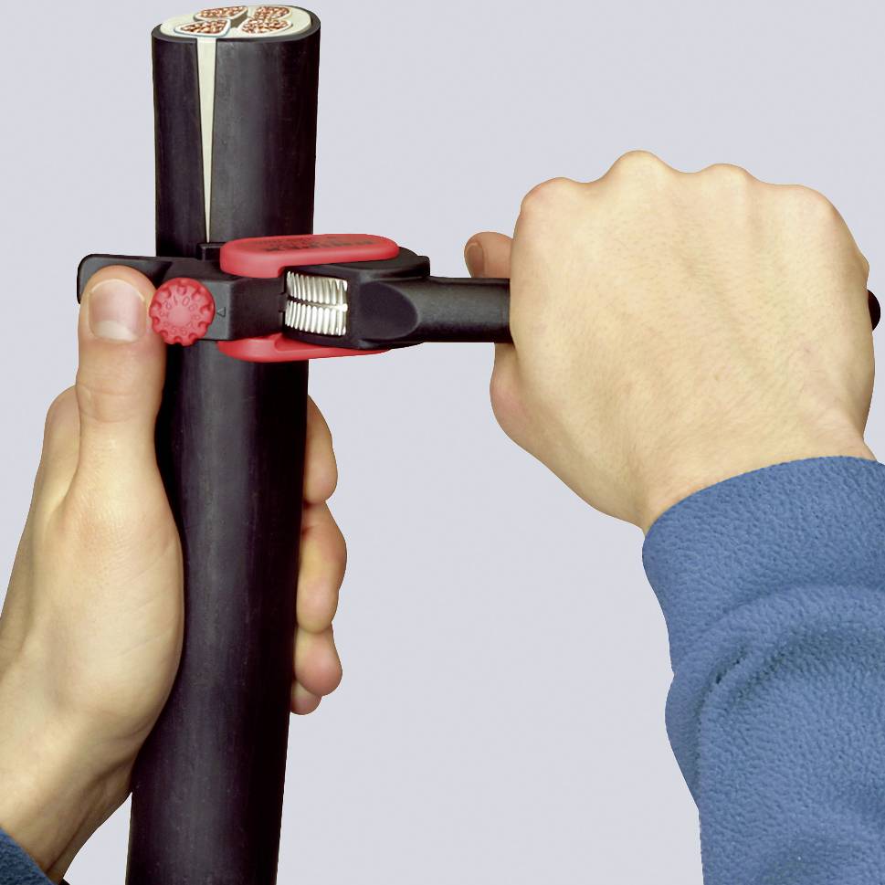 A person is holding and adjusting the height of a foldable walking stick with a red clip lock.