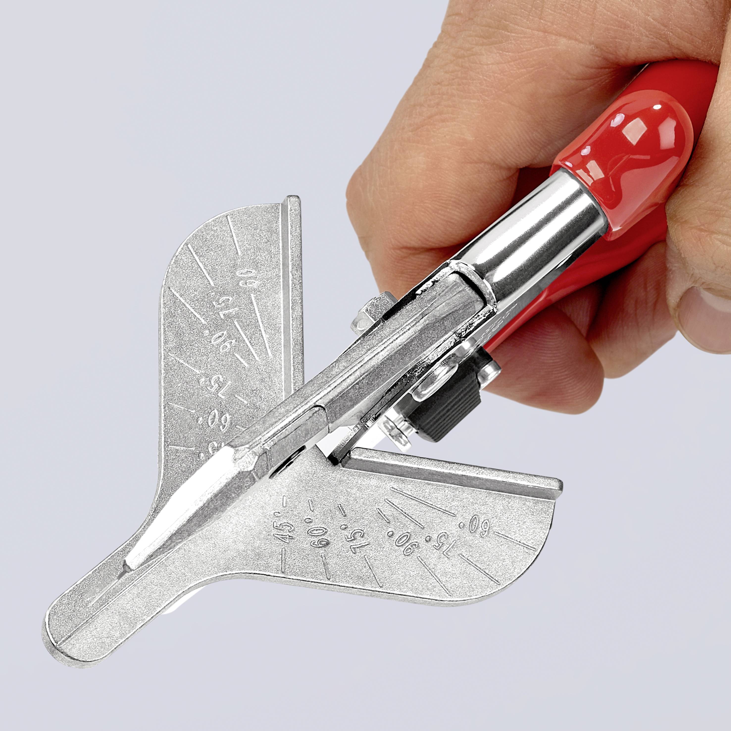 A hand is holding a red metal nibbler with a steel head, suitable for cutting metal sheets into curved shapes.