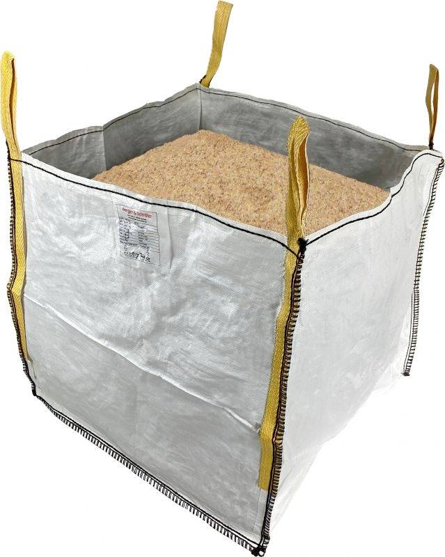 A large, white container filled with wood shavings, equipped with yellow carrying handles at the corners.